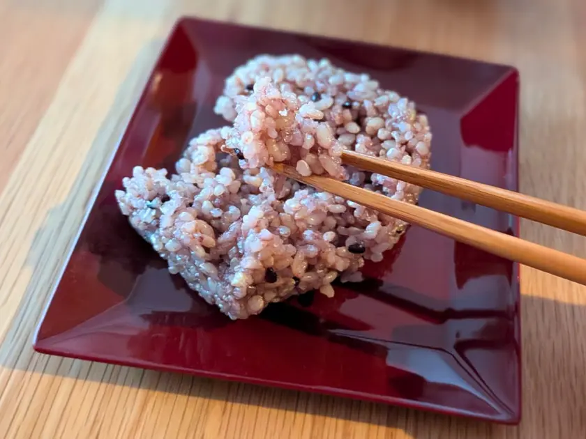 加熱した寝かせ玄米おむすびを箸でほぐす